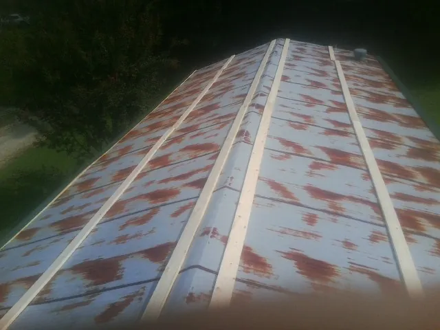 Rusted metal roof panels with new wood purlins before replacement — Storm Damage Roof Repair in Lacon by Roofing Brothers